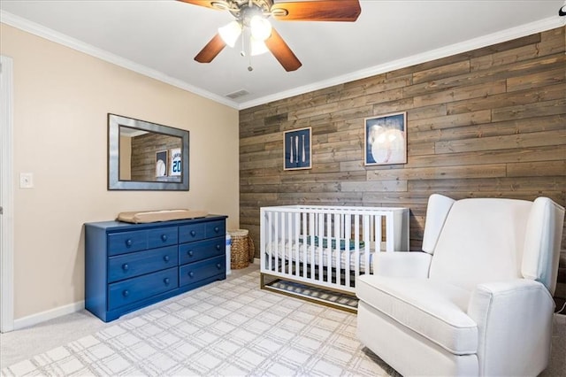 bedroom featuring crown molding, ceiling fan, and wooden walls