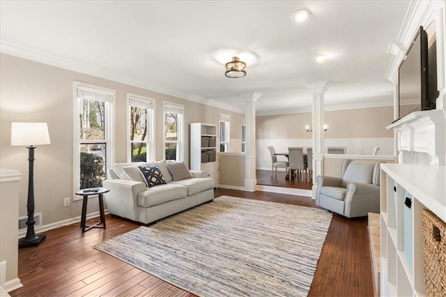 living room featuring ornamental molding, dark hardwood / wood-style floors, and ornate columns