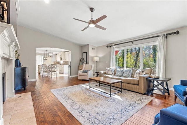 living room with hardwood / wood-style floors and ceiling fan