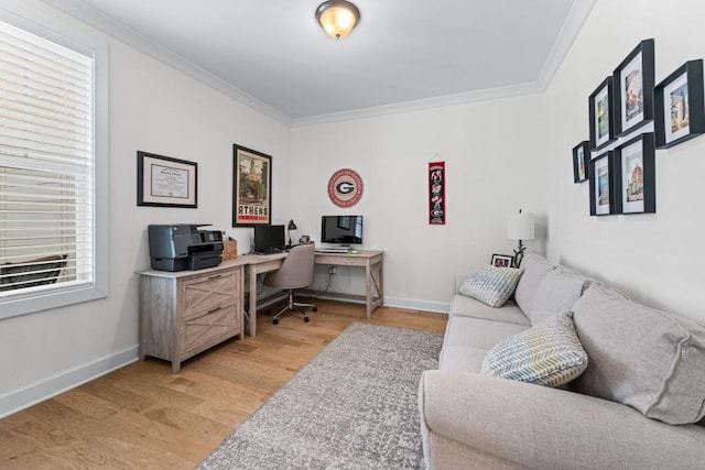 office area with light wood-type flooring, baseboards, and crown molding