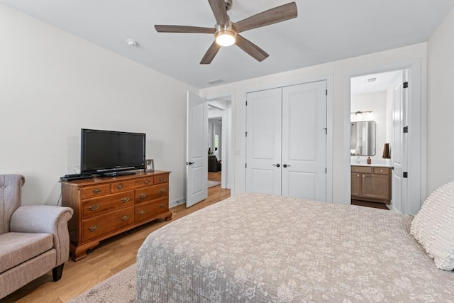 bedroom with connected bathroom, a closet, light wood-style floors, and ceiling fan