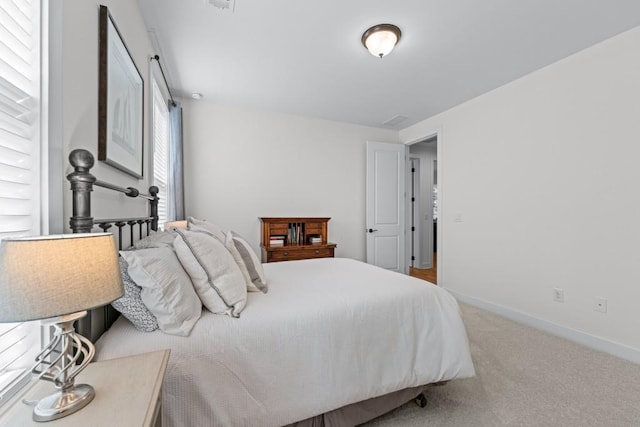 bedroom with baseboards and carpet flooring