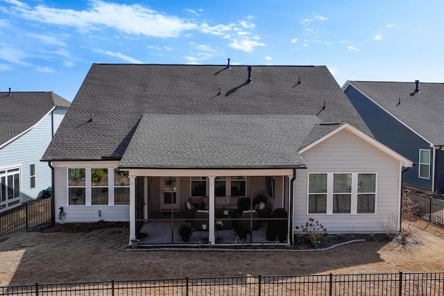 back of property with a patio, a shingled roof, fence private yard, and a sunroom