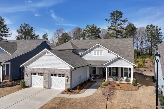 craftsman inspired home with driveway, a shingled roof, and a garage