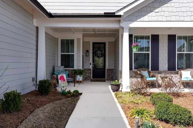 view of exterior entry featuring a porch