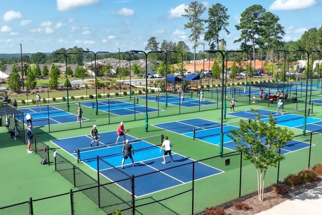 view of tennis court featuring fence