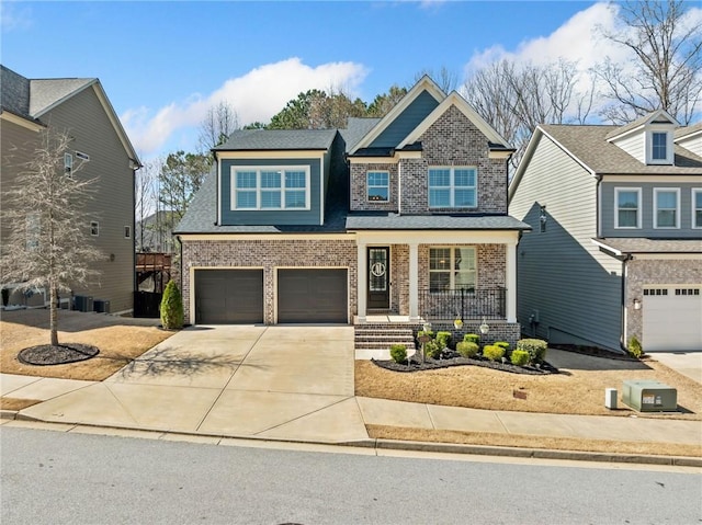 craftsman-style house with a garage, brick siding, covered porch, and driveway