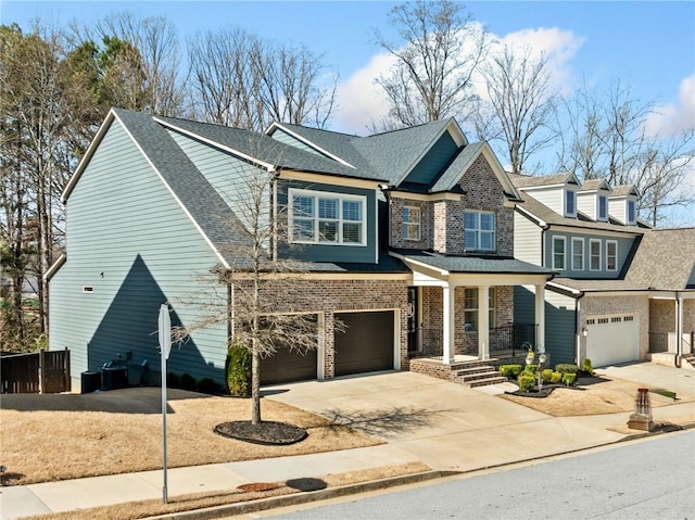 view of front of property with brick siding, concrete driveway, a garage, and a shingled roof