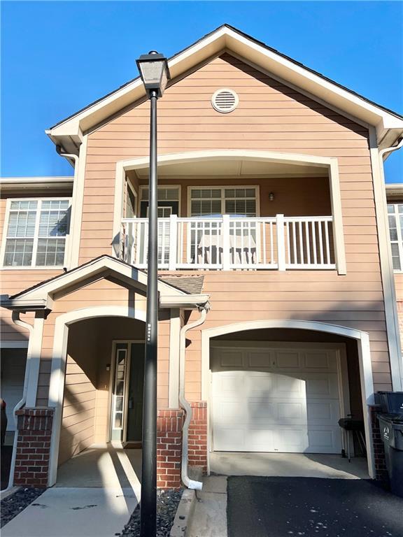 view of front of house with a garage and a balcony