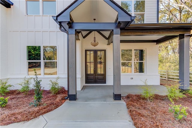 entrance to property featuring french doors and a porch