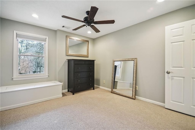 unfurnished bedroom featuring light carpet and ceiling fan