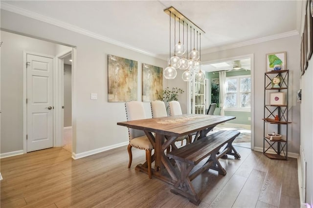 dining area with crown molding and wood-type flooring