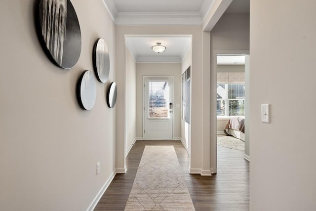 doorway to outside featuring crown molding and dark hardwood / wood-style floors