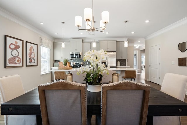 dining space featuring dark hardwood / wood-style flooring, ornamental molding, and a chandelier