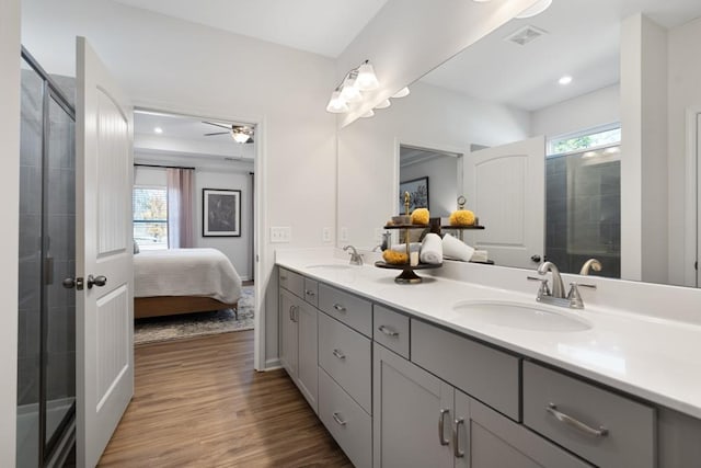 bathroom with vanity, hardwood / wood-style flooring, a wealth of natural light, and ceiling fan