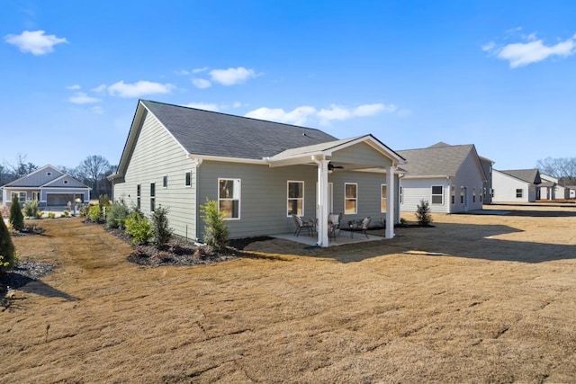 rear view of house with a yard and a patio