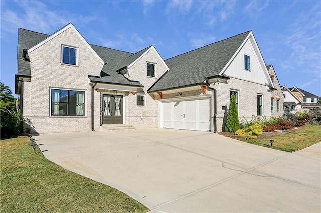 french country inspired facade featuring a front yard and a garage