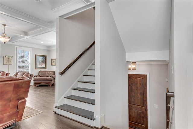 staircase with recessed lighting, coffered ceiling, wood finished floors, ornamental molding, and beam ceiling