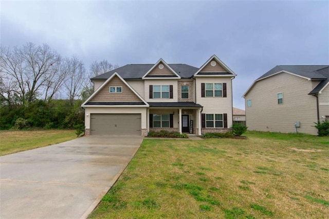 craftsman-style house featuring an attached garage, concrete driveway, and a front yard