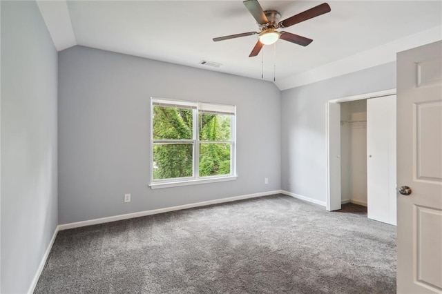 unfurnished bedroom featuring vaulted ceiling, ceiling fan, a closet, and carpet floors