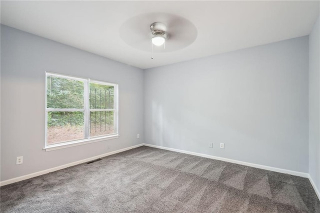 unfurnished room with ceiling fan and carpet flooring