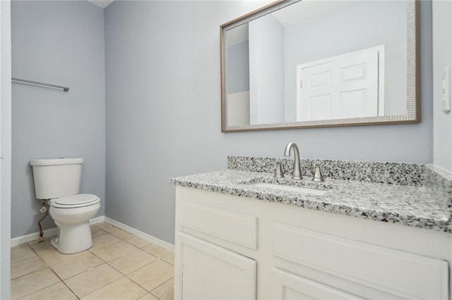 bathroom featuring tile patterned floors, vanity, and toilet