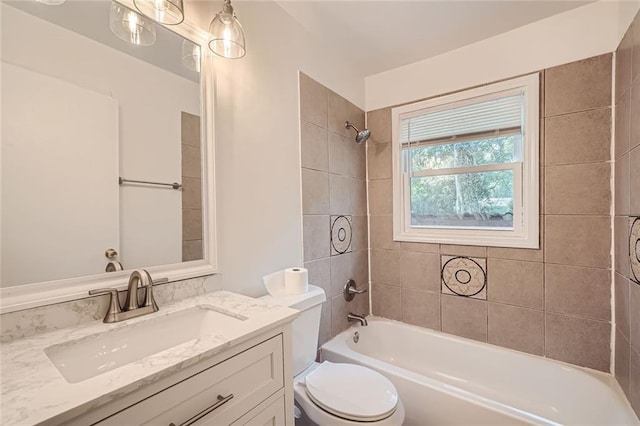 full bathroom with tiled shower / bath combo, toilet, and vanity