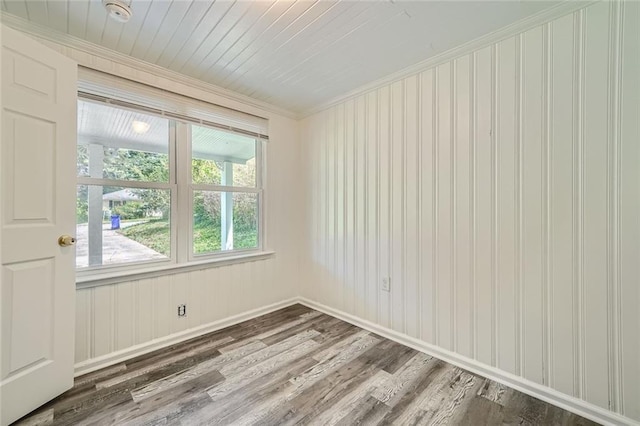 spare room featuring crown molding and wood-type flooring