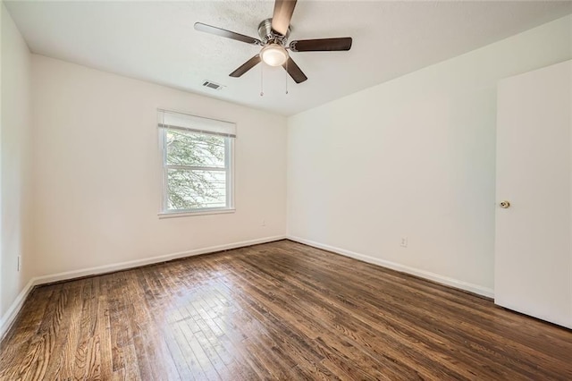 spare room featuring ceiling fan and dark hardwood / wood-style flooring