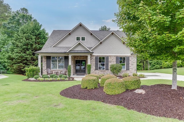 7070 Concord Mountain Trl, Cumming, GA 30028 - craftsman-style home featuring french doors, a front yard, brick siding, and a shingled roof