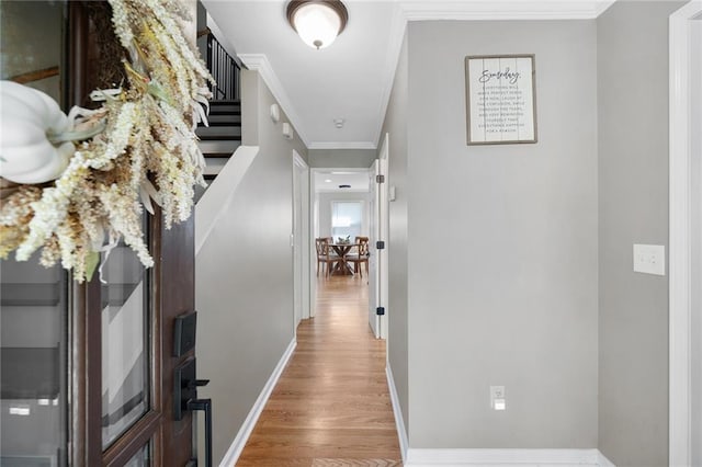 hall with ornamental molding and hardwood / wood-style floors