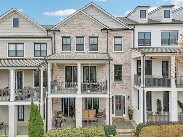 115 Harlow Cir, Roswell, GA 30076 - exterior space featuring brick siding, metal roof, a standing seam roof, and a patio