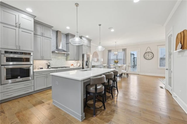 115 Harlow Cir, Roswell, GA 30076 - kitchen with gray cabinets, ornamental molding, stainless steel appliances, a sink, and wall chimney exhaust hood