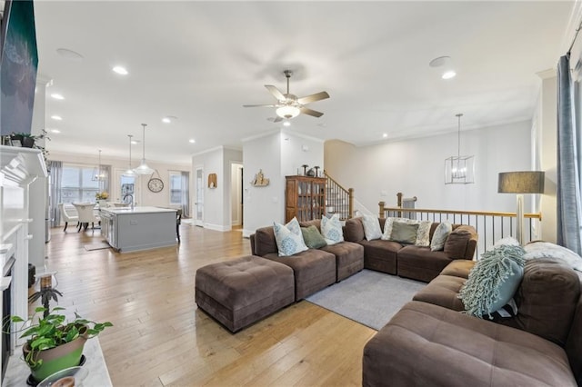 115 Harlow Cir, Roswell, GA 30076 - living area featuring recessed lighting, ornamental molding, ceiling fan with notable chandelier, baseboards, and light wood finished floors