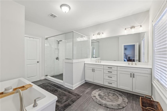 115 Harlow Cir, Roswell, GA 30076 - full bath featuring a stall shower, a freestanding tub, a sink, visible vents, and double vanity