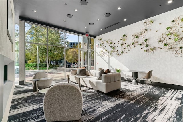 3324 Peachtree Rd NE Unit 1813, Atlanta, GA 30305 - living area featuring carpet, floor to ceiling windows, recessed lighting, and a towering ceiling