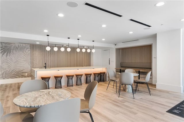 3324 Peachtree Rd NE Unit 1813, Atlanta, GA 30305 - dining space with a community bar, recessed lighting, light wood finished floors, and baseboards