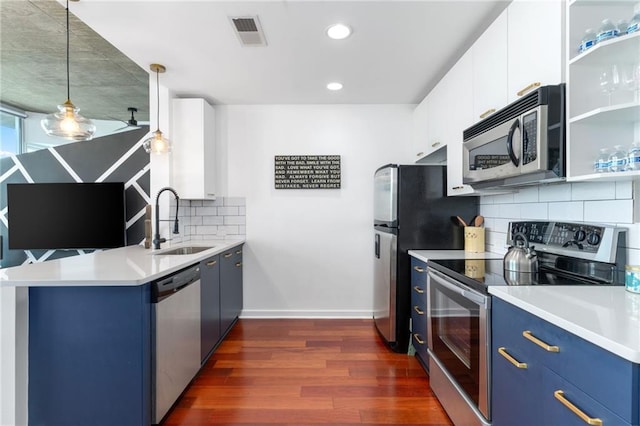 3324 Peachtree Rd NE Unit 1813, Atlanta, GA 30305 - kitchen with appliances with stainless steel finishes, blue cabinetry, a sink, a peninsula, and recessed lighting