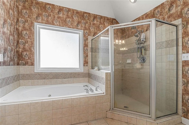 bathroom with tile patterned floors, shower with separate bathtub, and vaulted ceiling