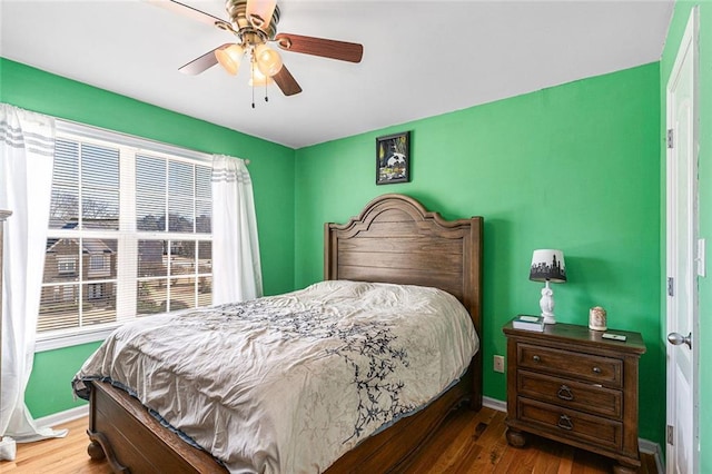 bedroom featuring hardwood / wood-style flooring and ceiling fan