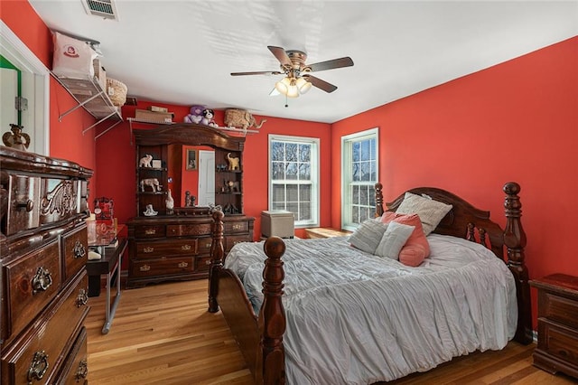 bedroom with ceiling fan and light hardwood / wood-style flooring