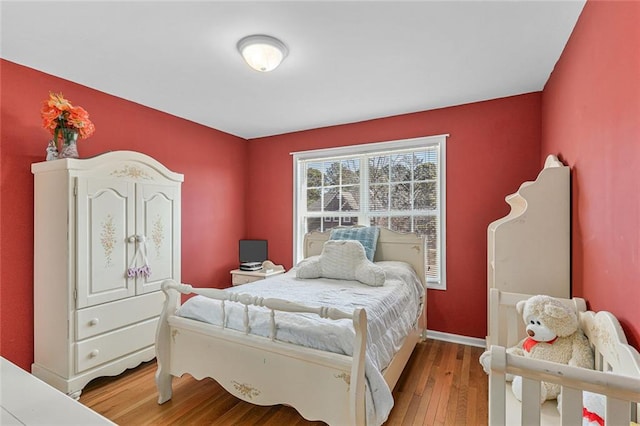 bedroom with hardwood / wood-style flooring