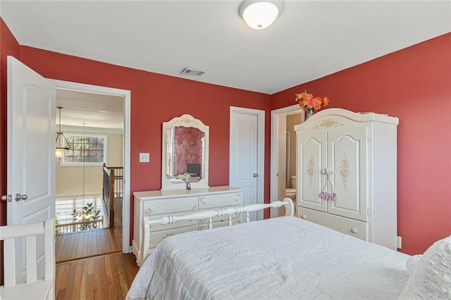 bedroom with wood-type flooring