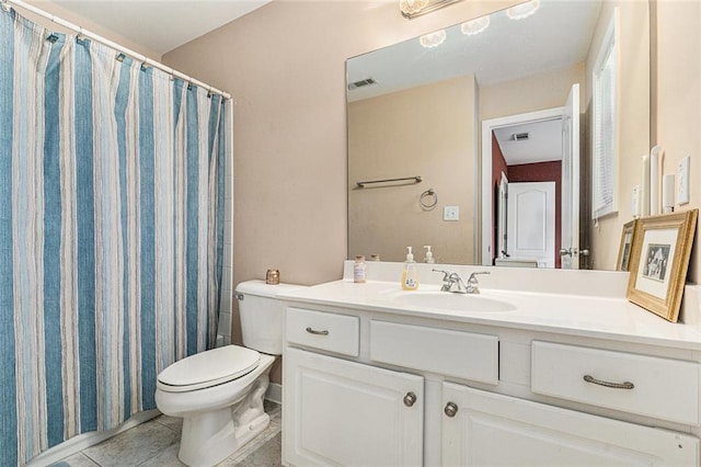 bathroom with tile patterned floors, vanity, and toilet