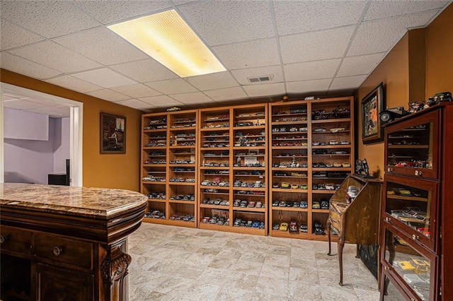 wine room with a paneled ceiling