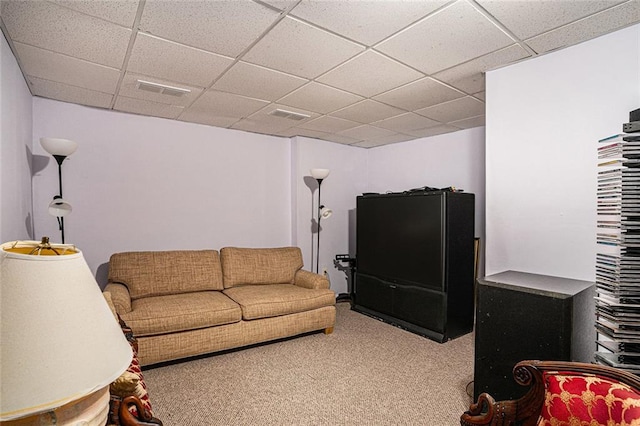 carpeted living room with a paneled ceiling