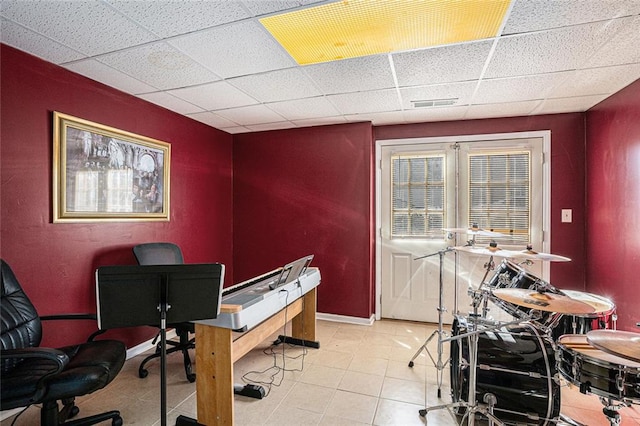 office with a paneled ceiling and light tile patterned floors