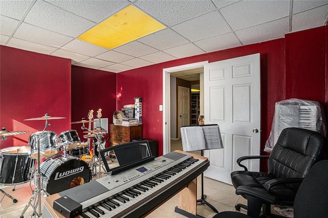 miscellaneous room featuring light tile patterned floors and a paneled ceiling