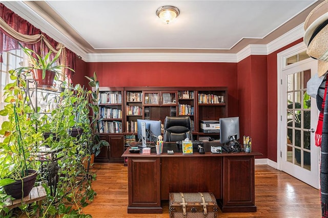 office with crown molding, french doors, and hardwood / wood-style flooring