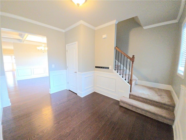 stairway with a chandelier, hardwood / wood-style floors, and crown molding